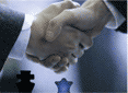 Handshaking men in business attire.